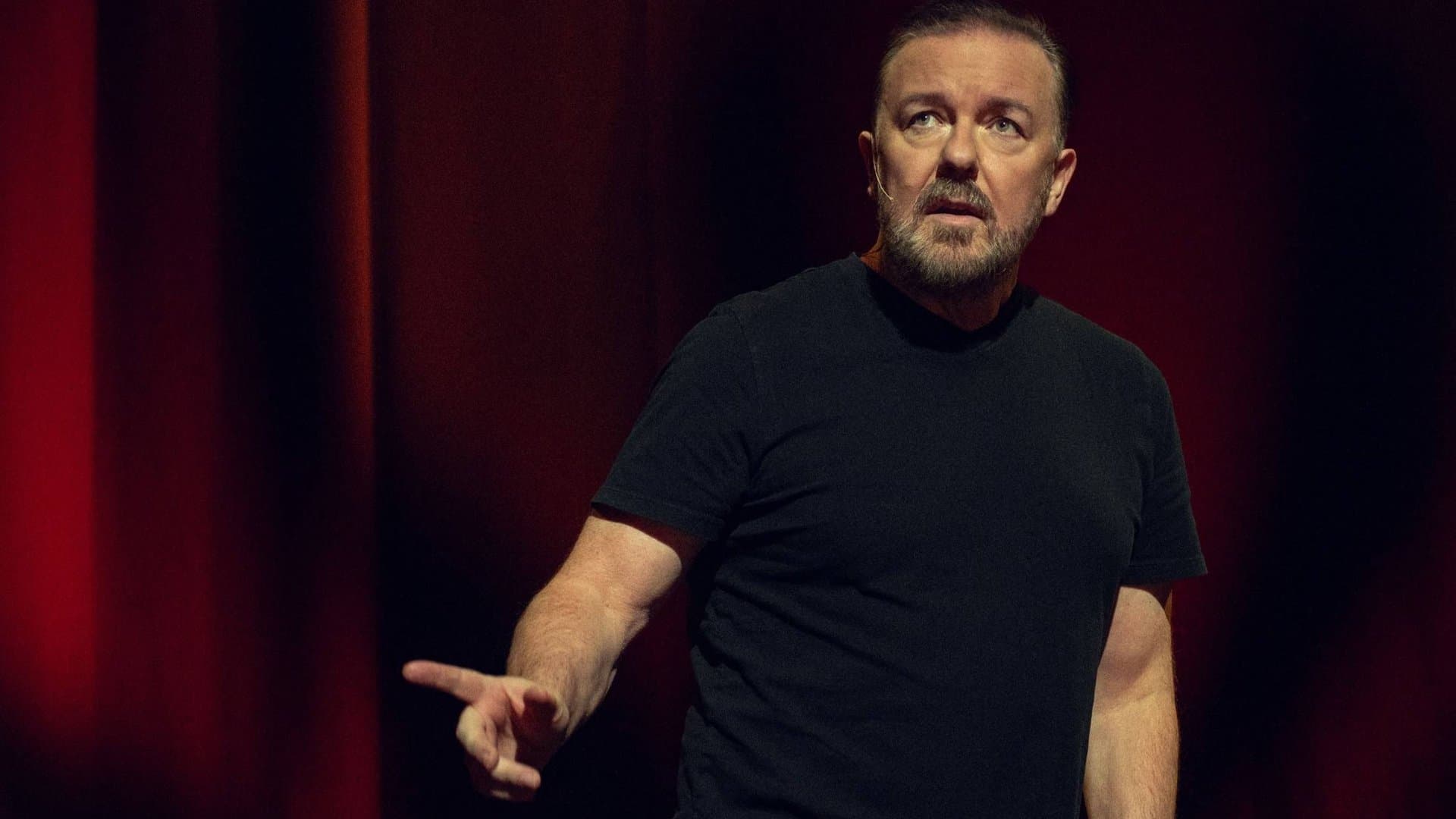 Ricky Gervais in his element on stage during a stand-up performance.