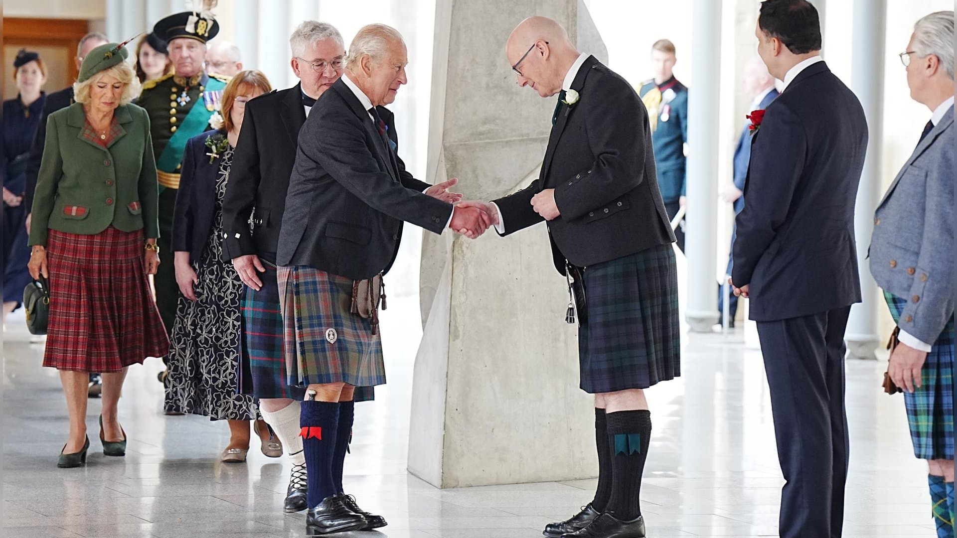 King Charles shakes the hand of John Swinney, the First Minister of Scotland.