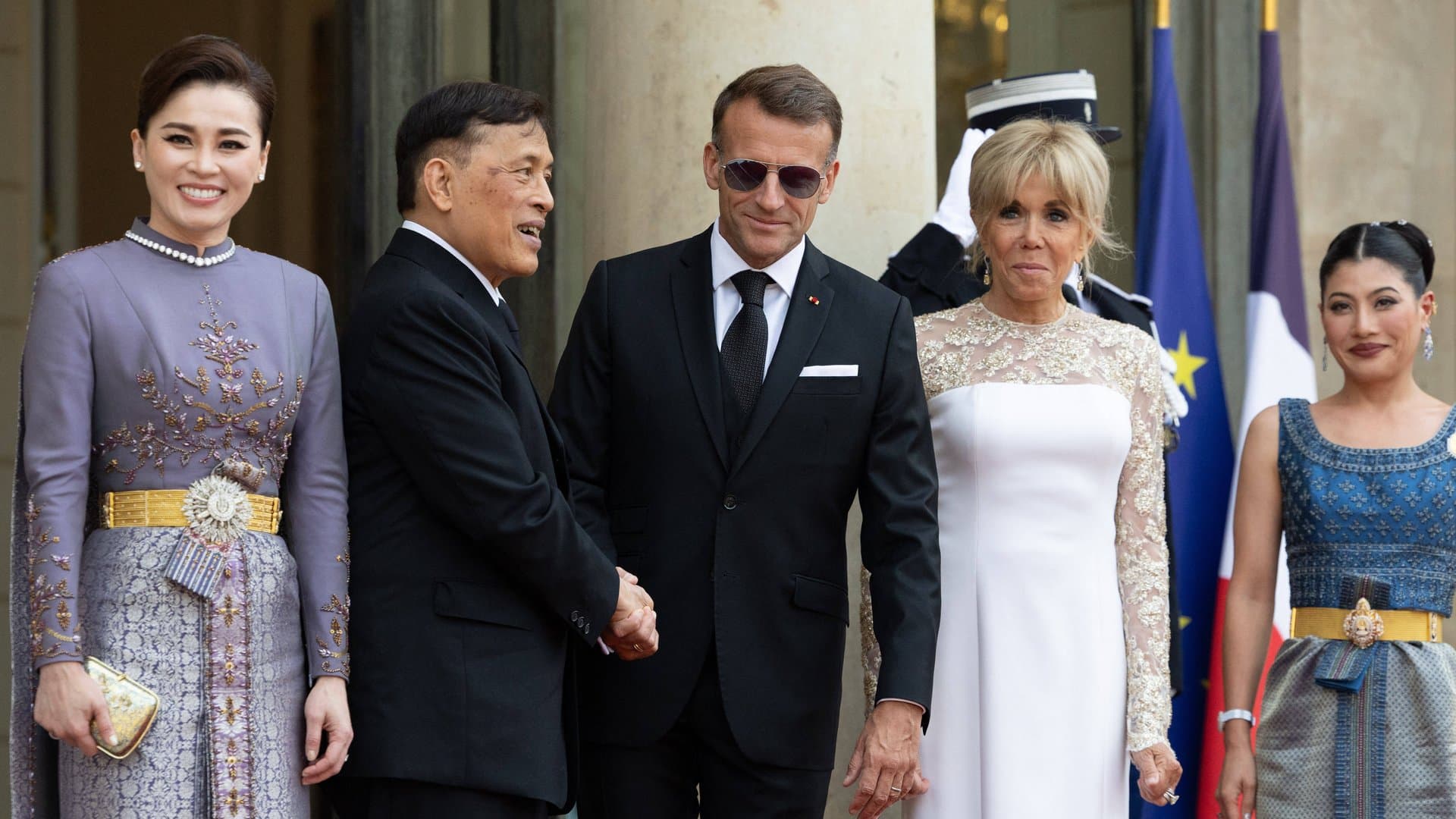 Queen Suthida (left) next to Rama X, Emmanuel and Brigitte Macron, and Princess Sirivannavari.
