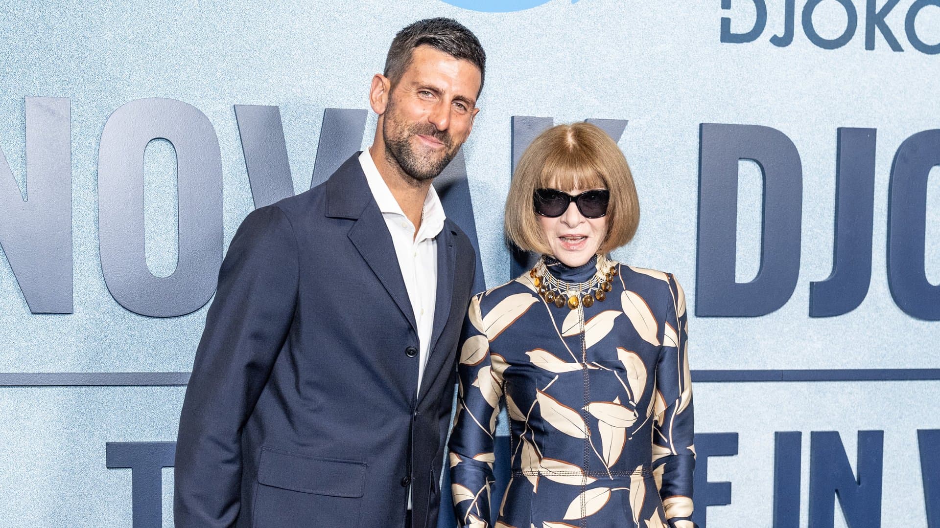 Novak Djokovic and Anna Wintour on the dark premiere carpet.